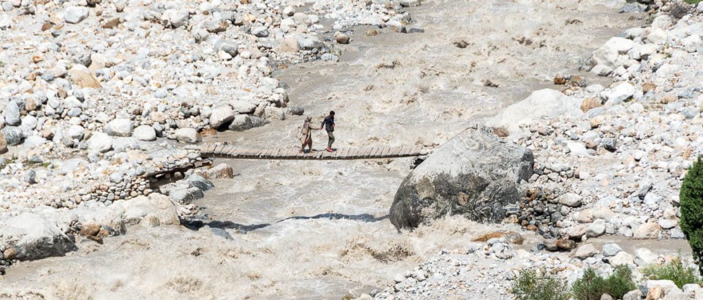 8 libros de viajes para disfrutar debajo de la manta o de la sombrilla 1 pareja cruzando un rio en pakistan libros de viajes para disfrutar